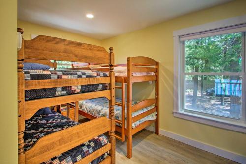 a room with three bunk beds and a window at Lakefront Meredith Home: Private Beach & Fire Pit! in Meredith
