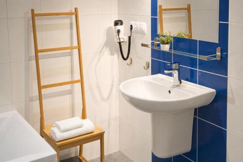 a bathroom with a sink and a mirror at Hotel CHODOV ASC in Prague