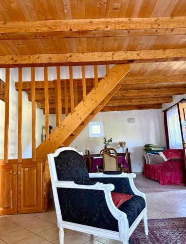 a living room with a chair and a wooden ceiling at Milovan in Cetinje