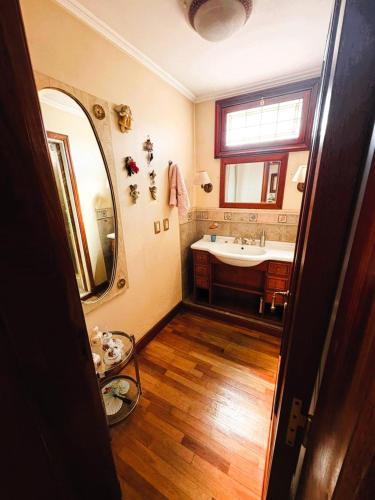 a bathroom with a sink and a mirror at HAUS EDELWEISS, Casa Quinta en Monte Grande, Bs As, EZEIZA AIRPORT, GARDEN, SWIMMING POOL in Monte Grande