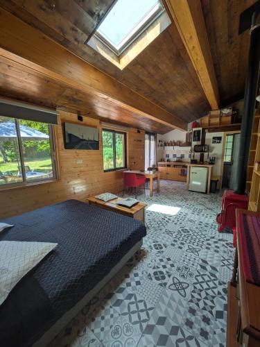 a bedroom with a large bed and a kitchen at LoFt Les Castilléres in Condat-sur-Trincou