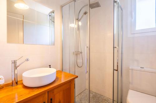 a bathroom with a sink and a shower at Chalet Cosy in Lège-Cap-Ferret