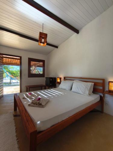 a bedroom with a large bed in a room at Villa Tarifa Suites in Amontada