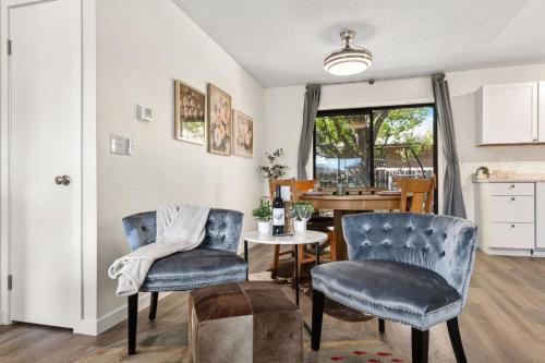 a living room with two chairs and a table at Backyard Hideaway with King Bed, Garage, Bicycles in Loveland