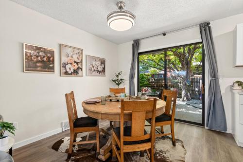 a dining room with a table and chairs and a window at Backyard Hideaway with King Bed, Garage, Bicycles in Loveland