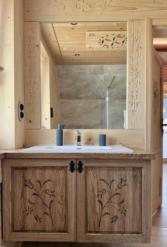 a bathroom with a wooden counter with a sink at Apartament Bioło Izba in Czerwienne