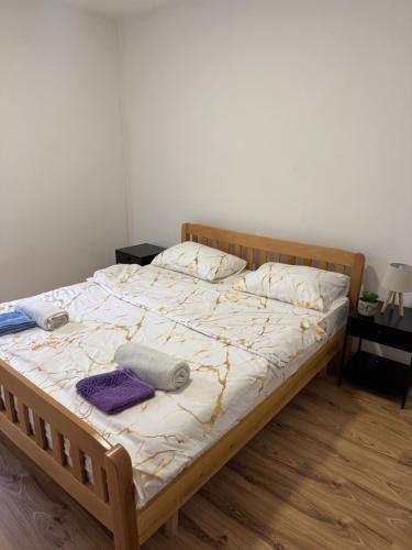 a bedroom with a bed with towels on it at Apartment Pantovic in Plužine