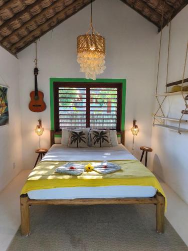 a bedroom with a large bed in a room at Green Coconut - Icaraí Kite Village in Icaraí