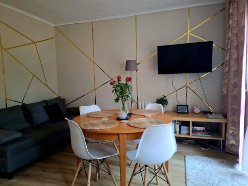 a living room with a table and a couch at Chillroom in Rąbień