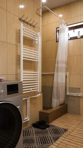 a bathroom with a shower and a washing machine at Syune House in Tatʼev