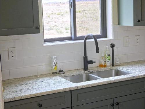 a kitchen counter with a sink and a window at Observer Ranch Campground & Learning Center in Penrose