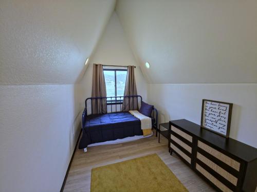 a small bedroom with a bed and a window at Observer Ranch Campground & Learning Center in Penrose