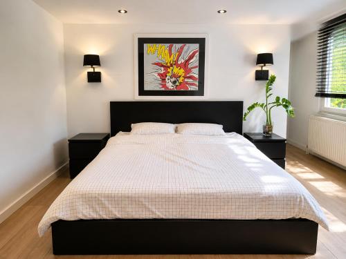 a bedroom with a large bed and two night stands at The Park Retreat in Schoten