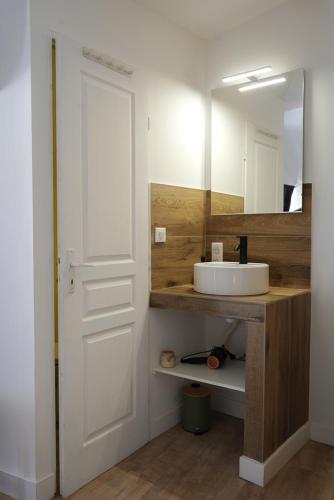 a bathroom with a white sink and a mirror at Le Loft in Sainte Anastasie - Aubarne