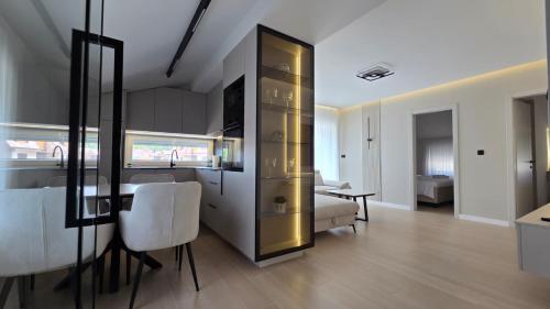 a kitchen and living room with a table and chairs at Apartman Premium Posušje in Posušje