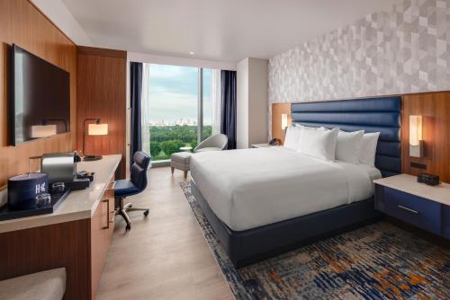 a hotel room with a large bed and a desk at Hollywood Casino & Hotel Columbus in Columbus