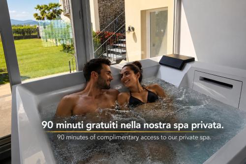 a man and a woman in a bath tub at Corte Tegassa Pool & Spa in Pinerolo