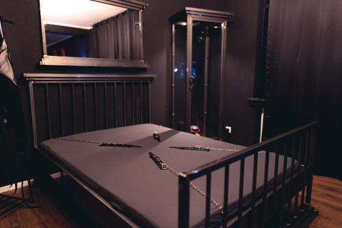 a room with a crib with a table and a mirror at Emotion Apartments- Erlebnis Apartment mit privater Sauna und Whirlpool in Vlotho