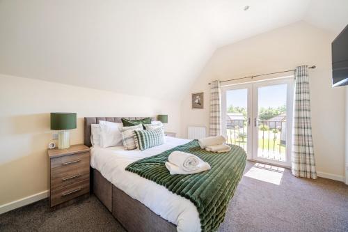 a bedroom with a large bed and a window at Sage Lodge in Brigg