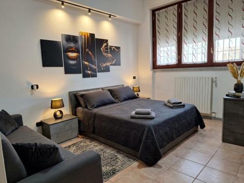 a bedroom with a bed and a couch at Jessy house in Cantù