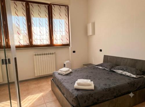 a bedroom with a bed with two towels on it at Jessy house in Cantù