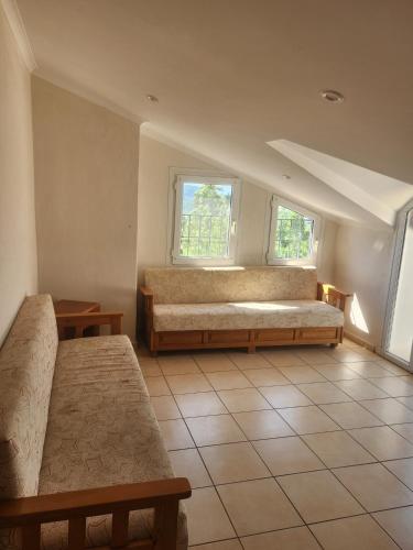 a room with two beds and two windows at Everest Apart Hotel in Oludeniz