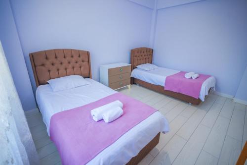 a bedroom with two beds with pink and white sheets at Antonelya Home in Sapanca