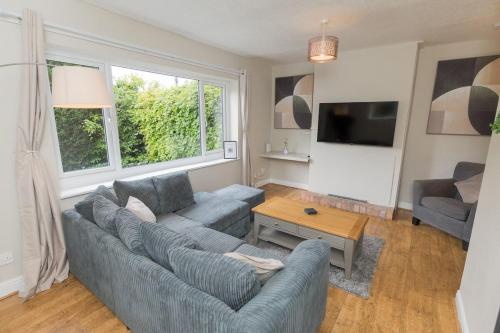 a living room with a couch and a table at Woodington House in Birmingham