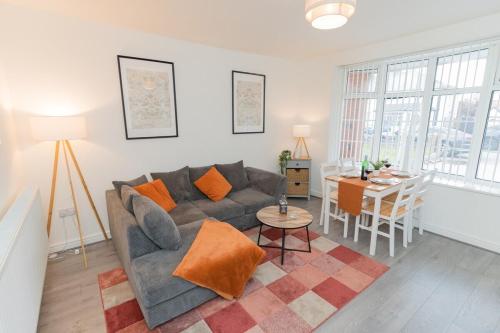 a living room with a couch and a table at Blackthorne House in Walsall