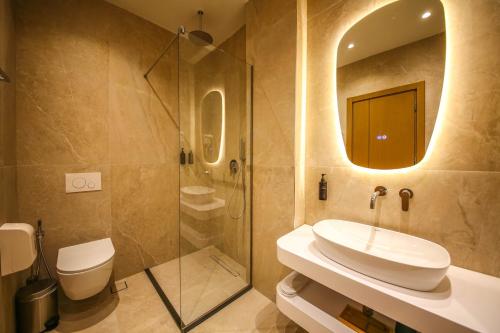 a bathroom with a sink and a shower at Hotel Lake Park Ksamil in Ksamil