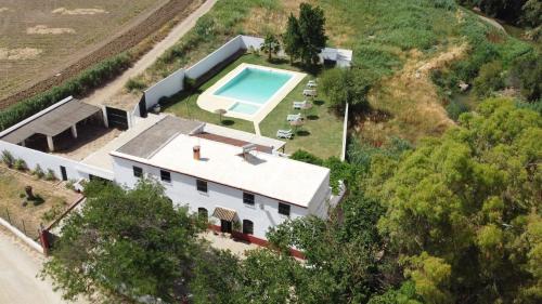 an aerial view of a house with a swimming pool at Casa Rural La Vega in Antequera