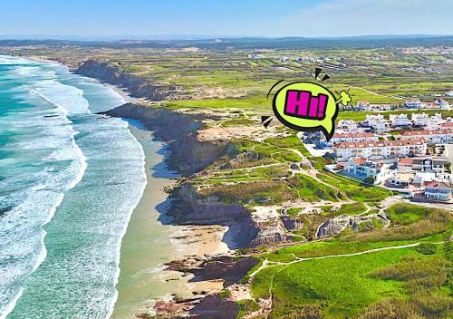 an aerial view of a beach with the hiji logo at Surfness Lodge in Baleal