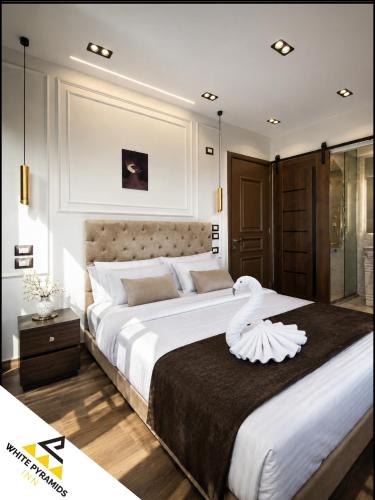 a bedroom with two large beds and a glass door at New White Pyramids Inn in Cairo