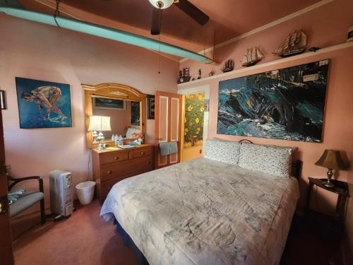 a bedroom with a large bed and a sink at The Inn at Castle Rock in Bisbee