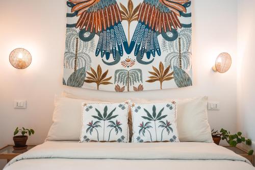 a bedroom with a bed with two pillows at Ethos Guest House in Quarto dʼAltino