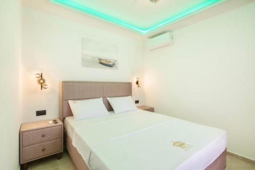a bedroom with a large white bed and a nightstand at Villa President 4 in Krimovice