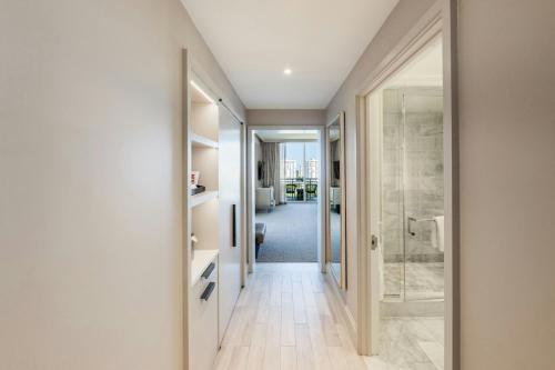 a corridor of a bathroom with a walk in shower at JW Marriott Miami Turnberry Resort & Spa in Aventura