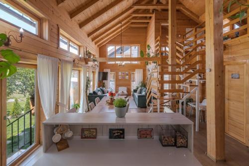 a wooden house with a large living room at Monte Chalet Kolašin brvnara sa saunom in Kolašin