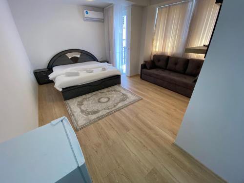 a living room with a bed and a couch at Venecia gold in Struga