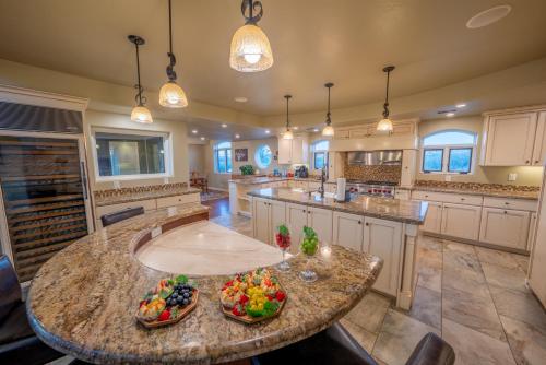 a large kitchen with a large island with fruits on it at Sorelle Vineyard in Cornville
