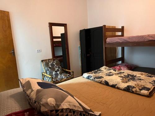 a bedroom with a bunk bed and a mirror at Loft D Mobiliado, individual com ar condicionado e garagem privada in Dourados