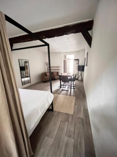 a bedroom with a bed and a dining room at naMaaStay in Maastricht