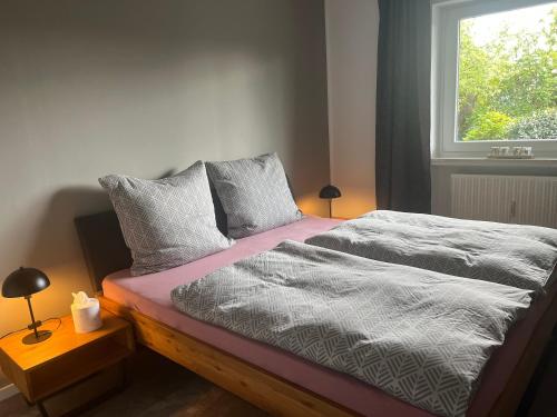 a bed in a room with a window and a bed sidx sidx sidx at Haus Blumenglück 2.0 in Herscheid