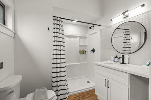 a white bathroom with a sink and a mirror at The Loft | Beach | Kayaks & Pickleball in Bremerton