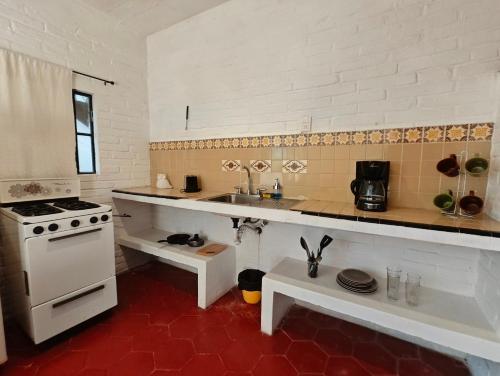 a kitchen with a sink and a stove at Casa Rey Sol Vallarta in Puerto Vallarta