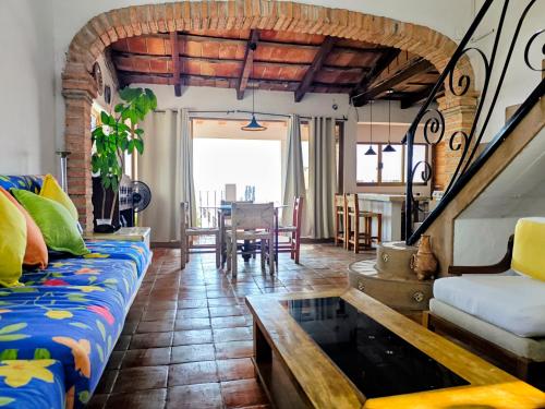 a living room with a couch and a table at Casa Rey Sol Vallarta in Puerto Vallarta