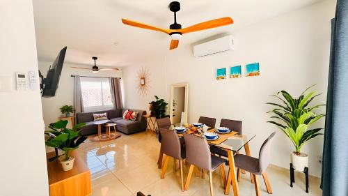 a dining room and living room with a table and chairs at Casa amplia y privada con alberca para una escapada perfecta in Playa del Carmen