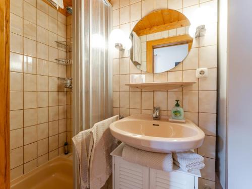 a bathroom with a sink and a mirror at Maria in Leogang