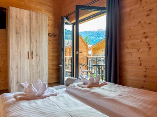 a bedroom with a bed and a large window at Rattendorf 5B in Rattendorf