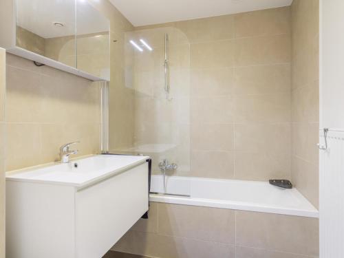 a bathroom with a sink and a bath tub at B City Complex - 0209 in Blankenberge